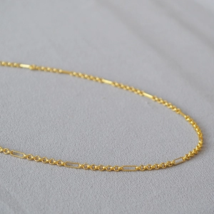 Minimalist gold plated brass necklace featuring interlocking round and oblong link chain