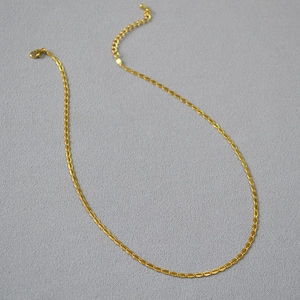 Detail of gold-plated coffee bean chain featuring a secure lobster clasp and adjustable link
