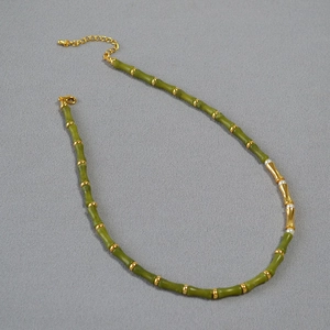 Elegant bamboo-style necklace with green beads, gold accents and small white pearls