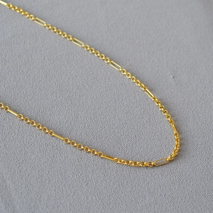 Detail of minimalist 18K gold plated brass necklace with oval link chain design