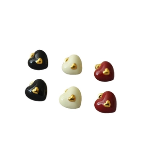 Minimalist enamel heart stud earrings set in black, cream, and red with gold accents