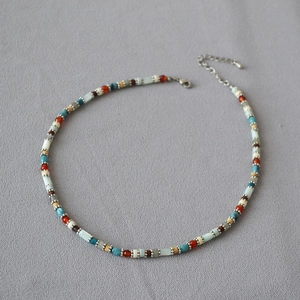 Close-up of bohemian colorful beaded necklace with lobster clasp and extension chain