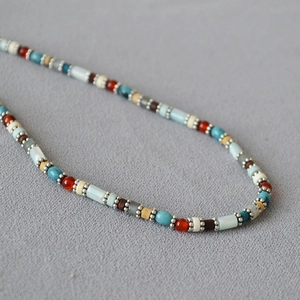 Detail of colorful beads including turquoise and agate on a double-layer necklace