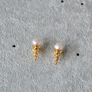 Detail of unique irregular pearl ice cream cone earrings in gold-toned finish