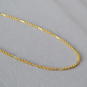 Minimalist gold-plated brass necklace with geometric interlocking rings and bars