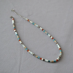 Detail of colorful bohemian beaded necklace with silver lobster clasp and extender