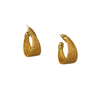 Textured gold-plated C-shaped earrings with vertical grooved patterns in a retro style