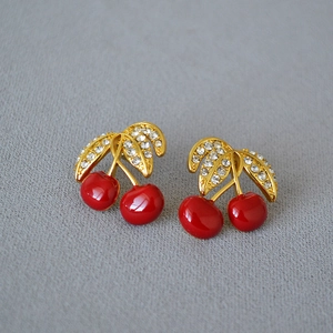 Vintage gold plated cherry stud earrings with red enamel and sparkling crystal leaves