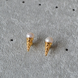 Detailed view of ice cream cone earrings with gold texture and white freshwater pearls