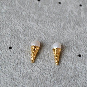 Detailed view of ice cream cone earrings with gold plating and white freshwater pearls