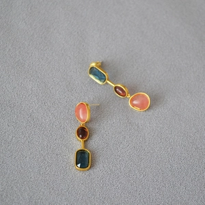 Three-tier colorful gemstone drop earrings with blue, red, and pink stones in gold finish