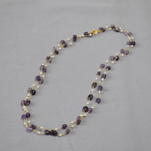Double-layered beaded necklace with purple natural stones and white pearls on gold chain