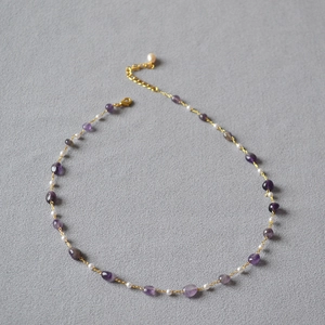 Detail of amethyst and pearl beaded necklace with gold chain and lobster clasp