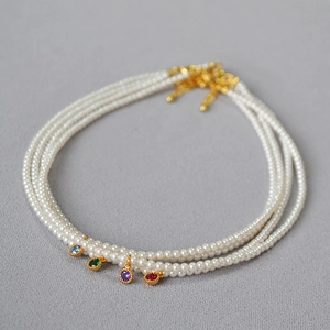 Elegant multi-strand pearl necklace with colorful zircon pendants and gold clasps