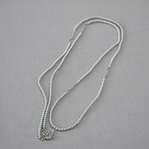 Detail of multi-layer long pearl necklace with silver chain and adjustable lobster clasp