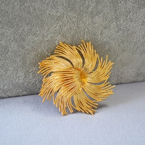 Vintage luxury gold-plated brass sunburst brooch with intricate twisted bead textures