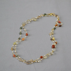 Detail of double-layer long necklace with natural colorful stones and white pearls