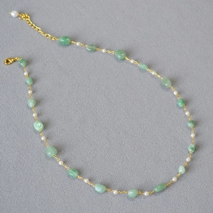 Minimalist necklace featuring natural green stone beads and white pearls on gold chain