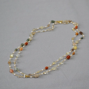 Handmade long necklace with colorful natural gemstones and pearls on a gold chain