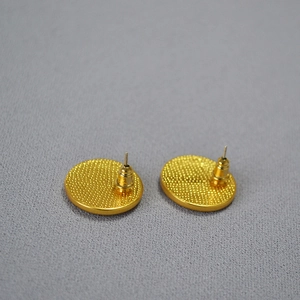 Back view of gold enamel camellia earrings with anti-slip texture and metal butterfly backs