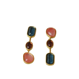 Vintage gold earrings with three-layer blue red and coral pink stones on white background