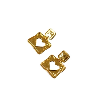 Retro hammered gold square drop earrings with heart cutout design on white background
