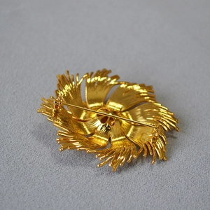 Vintage style gold floral brooch with brushed texture and secure back pin closure