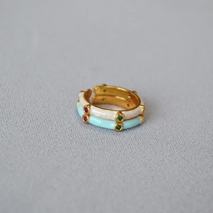 Detail of bamboo joint enamel rings with colorful zircon inlays for stackable styling