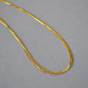 Italian minimalist multi-layer gold wire strand necklace with a glossy metallic finish