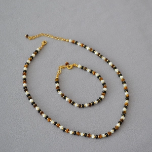 Tiger eye and onyx beaded necklace set with gold accents and lobster clasp