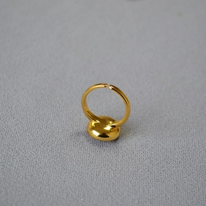 Close-up of vintage brass gold-plated adjustable ring with a polished disc element