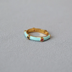 Detail of bamboo-style ring featuring light blue enamel and multi-colored cubic zirconia