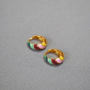 Colorful spiral enamel hoop earrings in gold plated brass with rainbow drip glaze design
