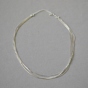 Close-up of silver minimalist multi-strand necklace with lobster clasp and extender