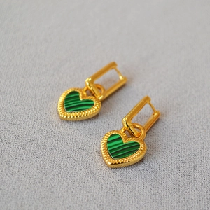 Detail view of gold vintage heart earrings with green malachite inlay and beaded texture