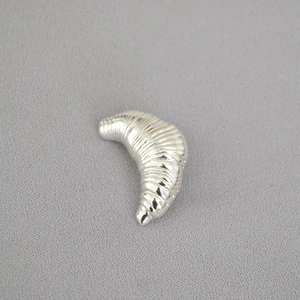 Minimalist silver croissant irregular brooch with a polished spiral horn design