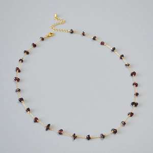 Minimalist gold chain necklace with irregular purple-red garnets and lobster clasp