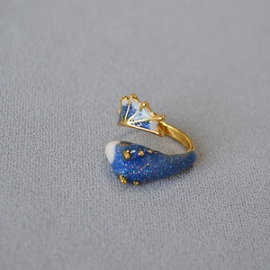Detail of whale shark ring with deep blue enamel and sparkling golden glitter finish
