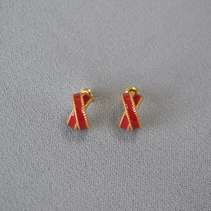 Crossed red enamel earrings with gold beaded edges and ribbon-shaped vintage design