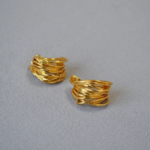 Detailed macro shot of French retro gold-plated multi-layer twisted wire stud earrings