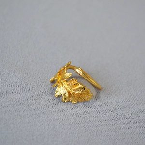Macro detail of golden adjustable ring featuring realistic oak leaf vein texture