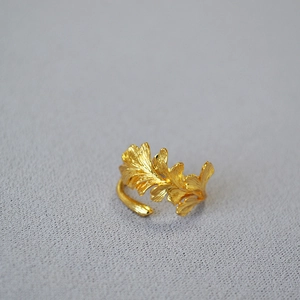 Detailed view of gold plated brass ring with layered ginkgo leaf textures and adjustable band