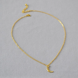 Elegant gold crescent moon necklace with colorful cubic zirconia and adjustable chain