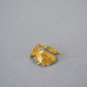Detail view of the textured oak leaf pattern on the adjustable gold brass ring