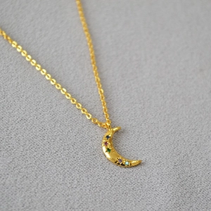Elegant gold-plated moon necklace with colorful zircon stones on a refined cable chain