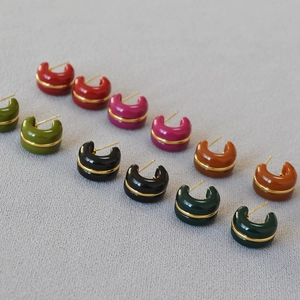Detail view of multi-color C-shaped resin hoop earrings with elegant gold wire inlay