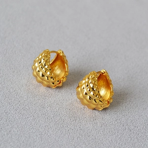 Textured gold ball hoop earrings with 3D embossed pineapple pattern on gray background