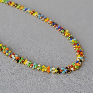 Bohemian colorful seed bead necklace with gold metal accents and handmade woven design