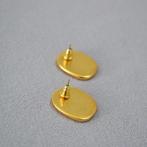 Matte gold oval stud earrings with 925 silver needles and bullet clutches