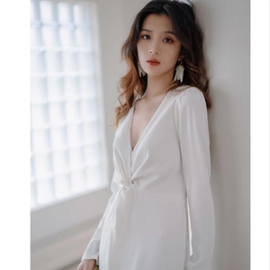 Elegant white V-neck long sleeve dress featuring sophisticated waist knot and pleated details
